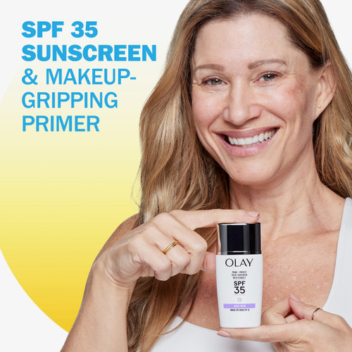 Model with Prime + Protect Facial Sunscreen with Vitamin C SPF 35 bottle in hand. SPF 35 sunscreen and makeip gripping primer